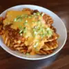 Waffle fries smothered with chili cheese