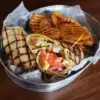 Crispy Chicken Wrap is served in a basket with waffle fries