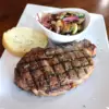 Stage Stop menu includes our Fire Grilled Ribeye Steak with sauteed veggies and garlic toast