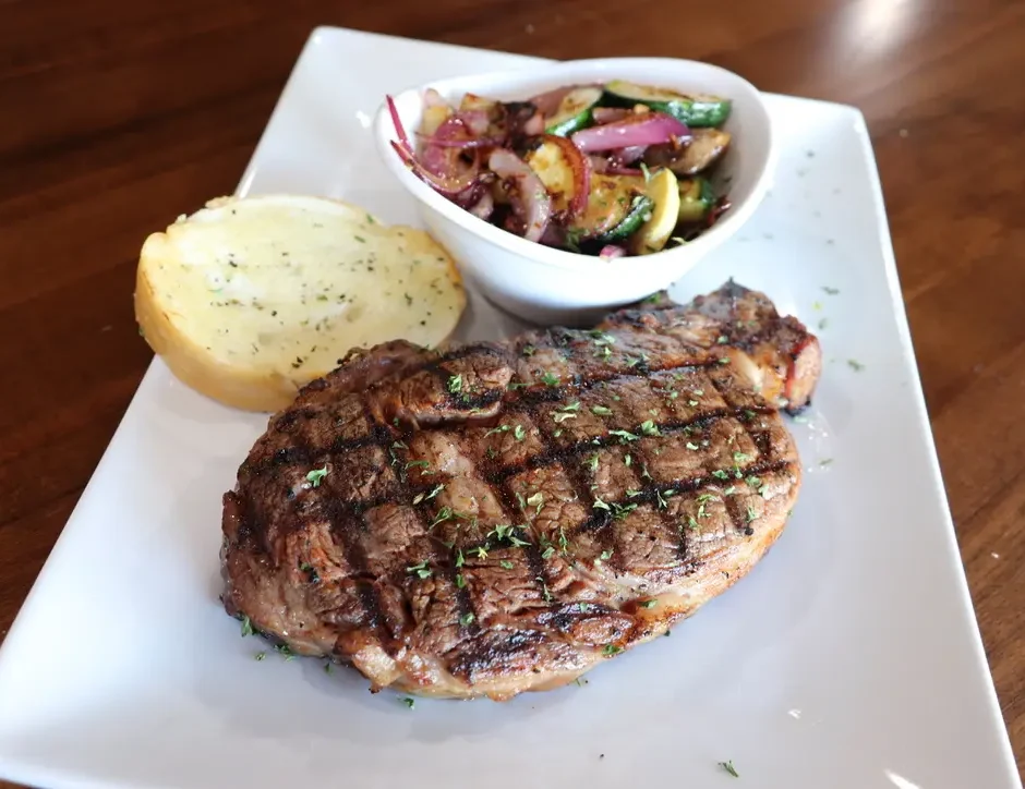 Stage Stop menu includes our Fire Grilled Ribeye Steak with sauteed veggies and garlic toast