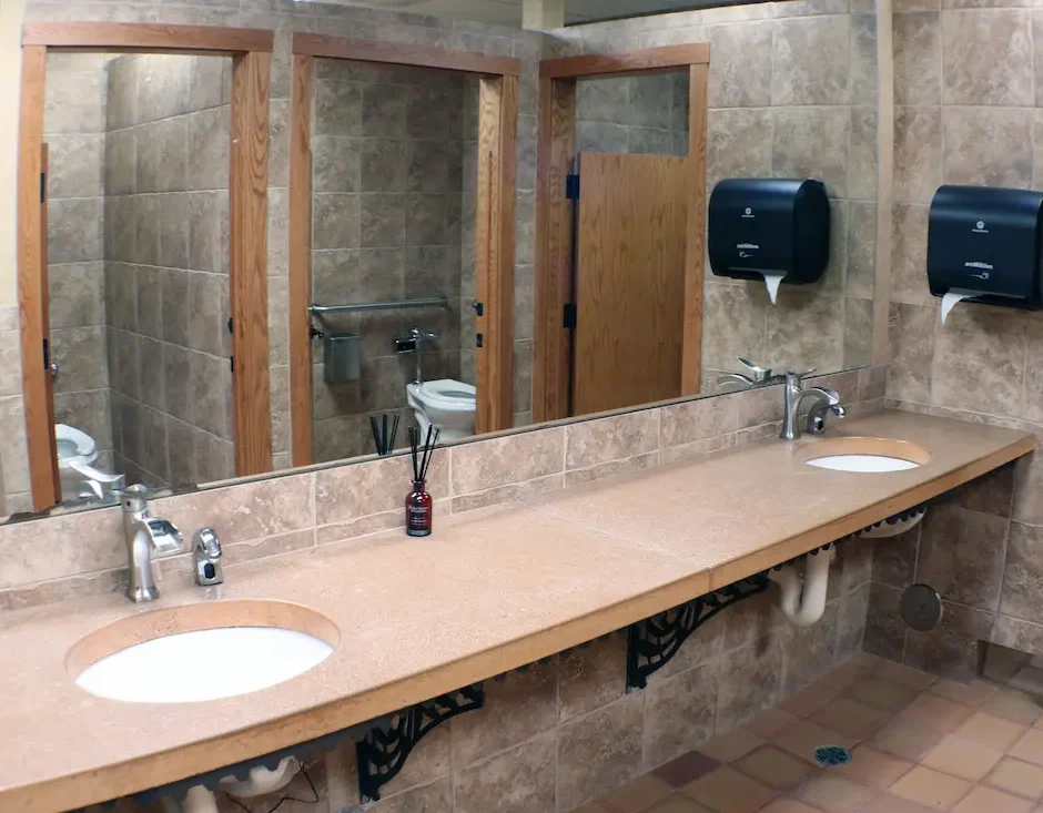 Fully remodeled bathroom on the main level of Stage Stop with a wide counter, two sinks and large mirror