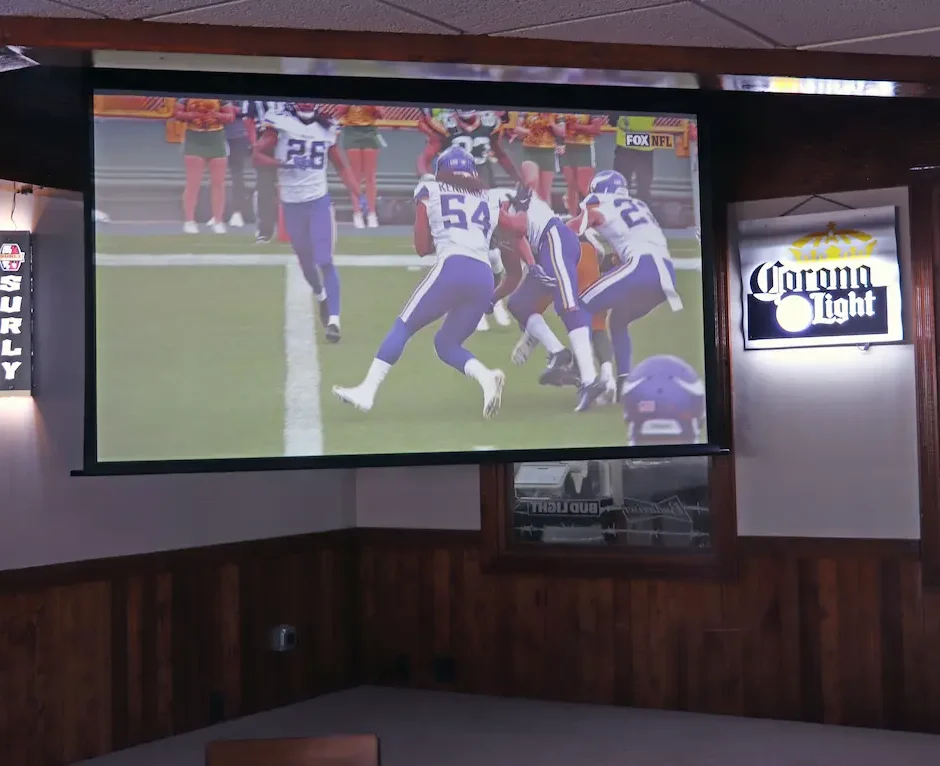 Large screen projector with an NFL game playing
