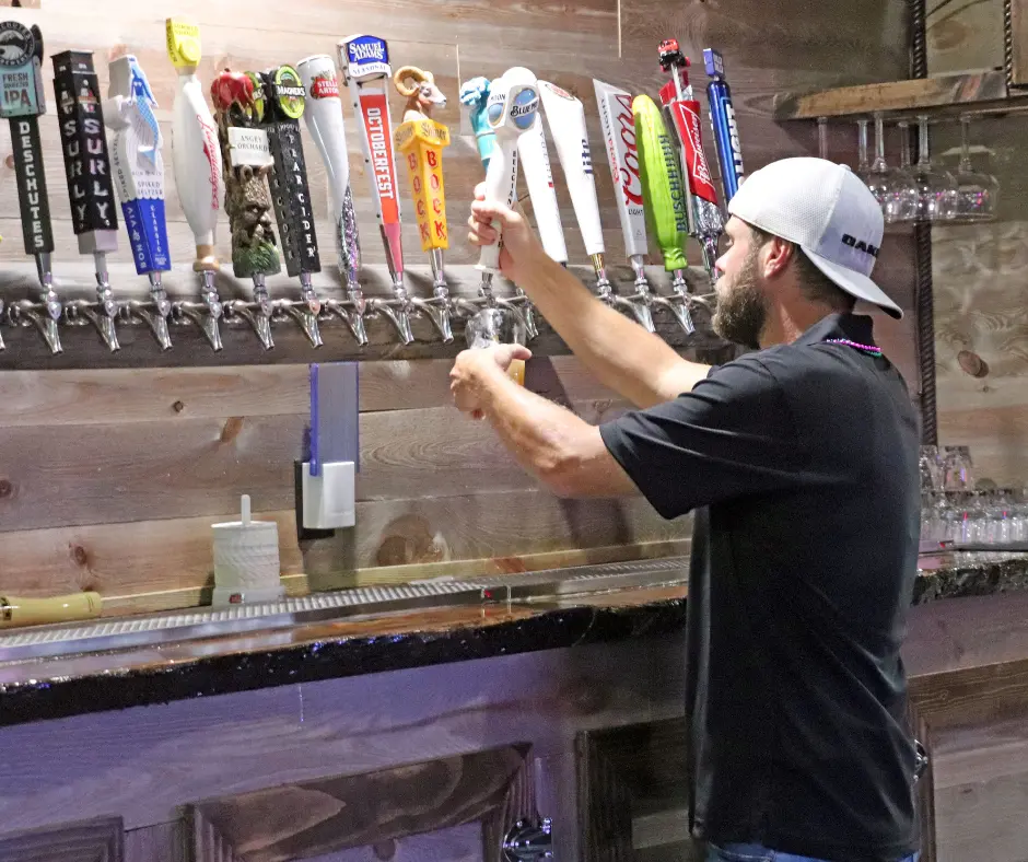 Man pouring beer from taps at Stage Stop