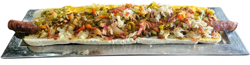 The Brutus Dog on a platter is 22 inches long with chili, bacon, cheese, onions, peppers, jalapenos, and sauerkraut on top.