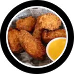 Basket of breaded chicken gizzards with dipping sauce