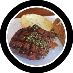 Sirloin steak on a plate with a baked potato and garlic toast